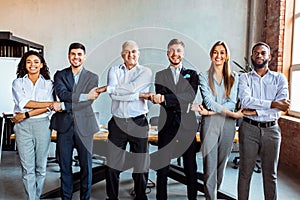 United Business Team Holding Hands Standing In Line In Office