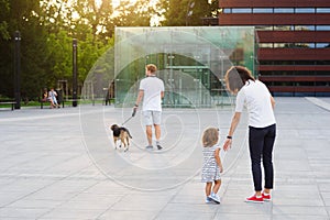 United family on a walk in the city park.