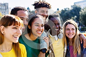 United group of multiracial young friends standing together outdoors