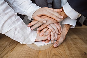 United hands of business team on workspace background