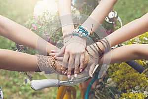 United hands of girlfriends closeup, young girls in boho bracelets