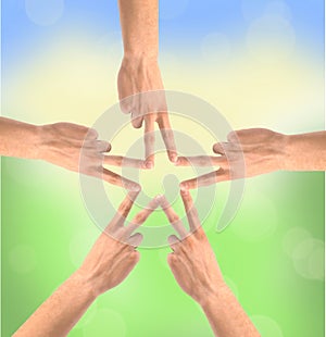 United hands over nature background. Conceptual photo of teamwork