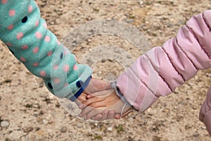 United hands of sisters in the field