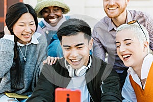 United happy multiracial young friends taking selfie portrait with mobile phone