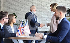 United Kingdom and American leaders shaking hands on a deal agreement