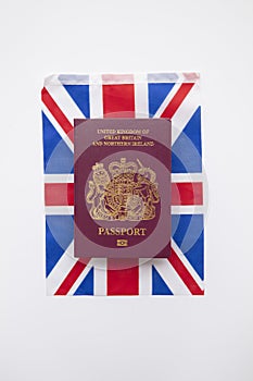 United Kingdom travel passport on a Great Britain Union Jack flag