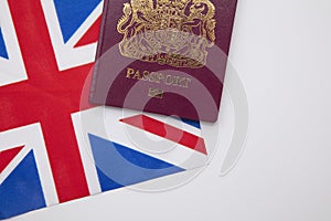 United Kingdom travel passport on a Great Britain Union Jack flag