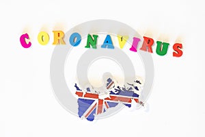 United Kingdom UK national flag on a white background with the inscription Corona virus made with letter board. Coronavirus is a