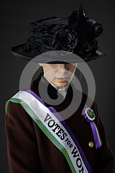 United Kingdom Victorian or Edwardian Suffragette with historically accurate sash and rosette photo