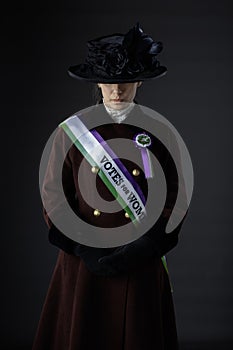 United Kingdom Victorian or Edwardian Suffragette with historically accurate sash and rosette photo