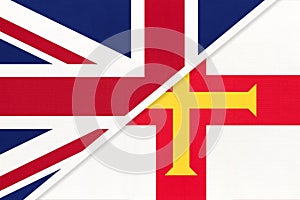 United Kingdom vs Bailiwick of Guernsey national flag from textile. Relationship between two european countries