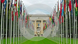 United Nations building with flags, Geneva, Switzerland, zoom out, 4K