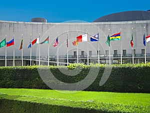 He United Nations General Assembly hall with flags of  their members in New York