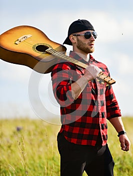 United with nature. Inspiring nature. Handsome man with guitar contemplate nature. In search of muse. Summer vacation