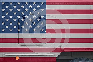 United States of America flag depicted on side part of military armored truck closeup. Army forces conceptual background