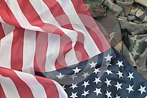 United States of America flag and folded military uniform jacket. Military symbols conceptual background banner for american