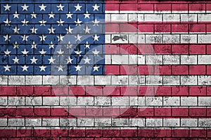 United States of America flag is painted onto an old brick wall