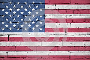 United States of America flag is painted onto an old brick wall