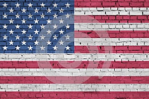 United States of America flag is painted onto an old brick wall