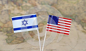 The United States of America and Israel flag pins on a world map background, political relations concept