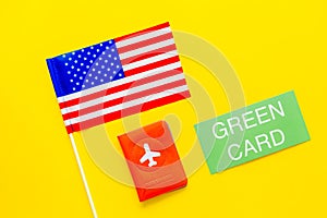 United States of America permanent resident cards. Immigration concept. Text green card near passport cover and US flag