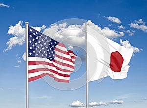 United States of America vs Japan. Thick colored silky flags of America and Japan. 3D illustration on sky background. -