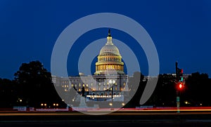 The United States Capitol building with the dome lit up at night the Senate and House sides of the building photo