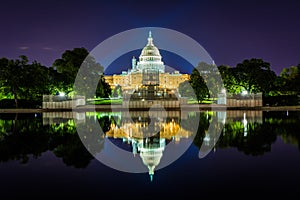 The United States Capitol Building and Reflecting Pool at night, in Washington, DC.