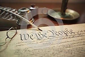 United States Constitution with quill, glasses and candle holder photo