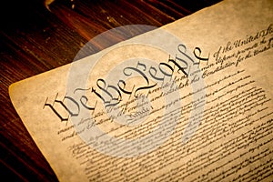 The United States Constitution on a wooden desk photo