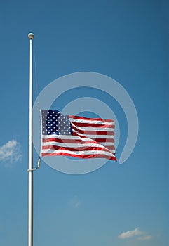 The United States flag flying at half-mast