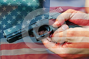 United States Gun Laws - Guns and weapons. A hand of man practicing firing using a Glock gun model at the shooting range. Fire