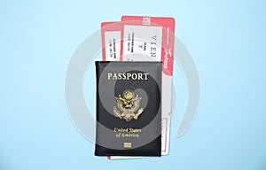 United States passport with tickets on blue background, top view