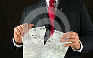 United States politician ripping up and shredding The Constitution representing corruption and injustice photo