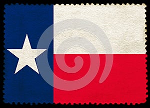 United States Texas state flag on the old grunge postage stamp isolated on black background