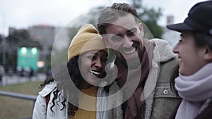 United young multiracial friends laughing and having fun in winter holidays