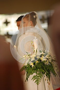 Unity candle with bride and groom at church