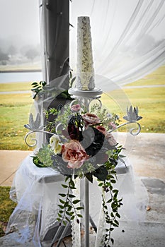 Unity Candle with flowers at an Outdoor Wedding