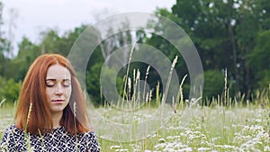 Unity with nature, young woman sits with closed eyes meditating, inner peace