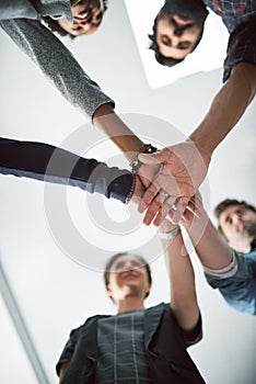 Unity is the secret to their success. a group of creative businesspeople stacking their hands on top of each other.