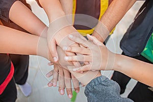 Unity and teamwork Concept: Group of friends hands together. Top view of Asian young people putting their hand together as Friends