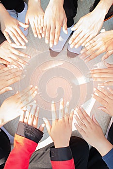 Unity and teamwork Concept: Group of students friends hands together. Top view of Asian young people putting their hand together