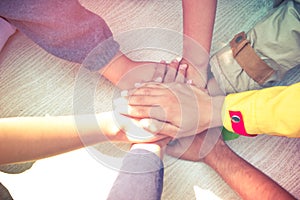 Unity and teamwork Concept: Group of students friends hands together. Top view of Asian young people putting their hand together