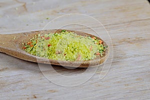 Universal bulk seasoning for dishes on a wooden background. Vegeta