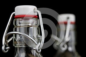 Universal closure of a beverage bottle. Airtight cap closing transparent glass container.