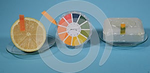 Universal indicator paper for pH value is shown in use on a lemon and a piece of hand soap