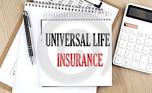 UNIVERSAL LIFE INSURANCE is written in white notepad near a calculator, clipboard and pen. Business concept
