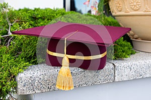 University graduate celebration cap worn with robe isolated on background