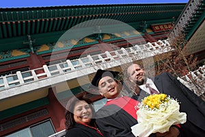 University graduate with his parents