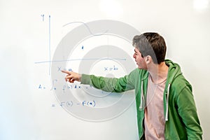 University student explaining integral calculus at whiteboard